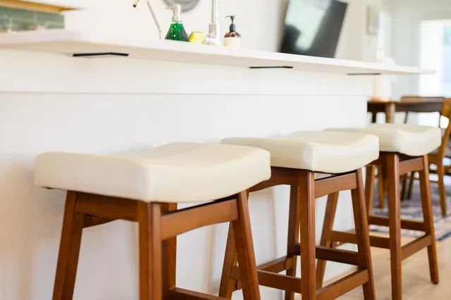 a large white kitchen with a lot of counter space and a sink