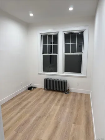 a view of an empty room with a window and workspace