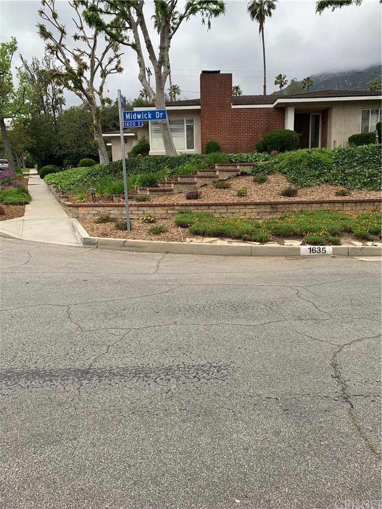 1635 Midwick Drive Altadena, CA 91001 - Photo 2 of 44 a front view of a house with a yard and a garage