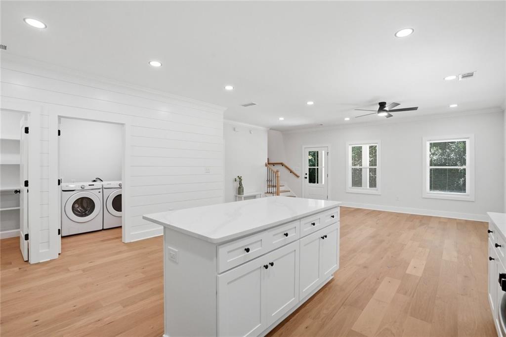 134 Henry Meyer Road Winterville, GA 30683 - Photo 10 of 34 a kitchen with a wooden floor and white appliances
