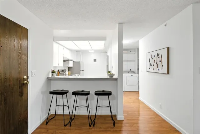 a kitchen with a refrigerator and a sink