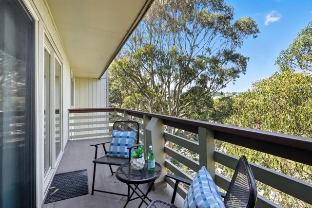 a balcony with chairs and with outdoor seating