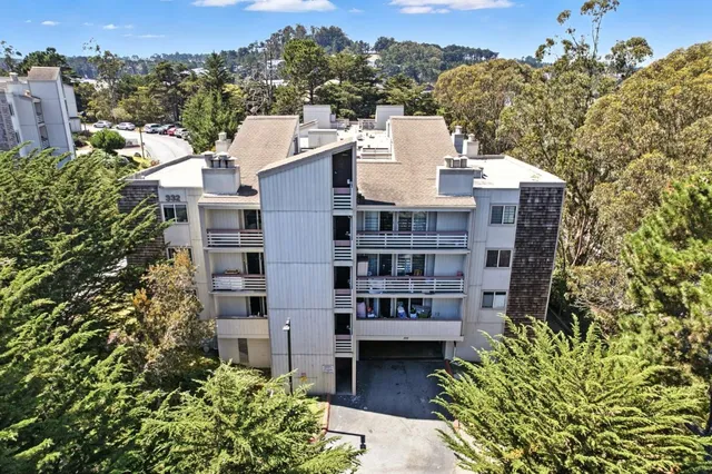an aerial view of residential houses with outdoor space