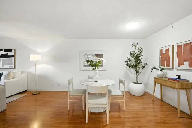 a view of a dining room with furniture and wooden floor
