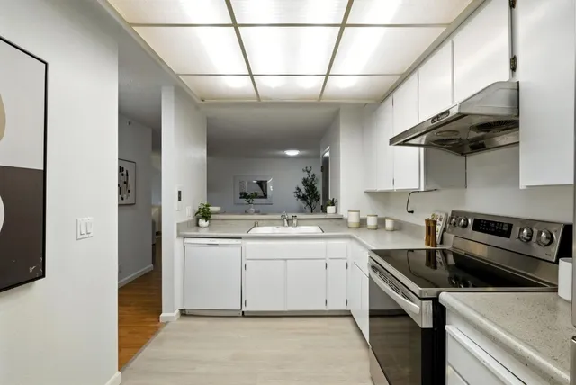 a kitchen with a sink appliances and cabinets