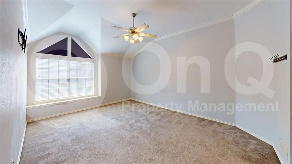 18240 Midway Road, Unit 1204 Dallas, TX 75287 - Photo 8 of 27 Carpeted room featuring a vaulted ceiling and a large arched window with blinds
