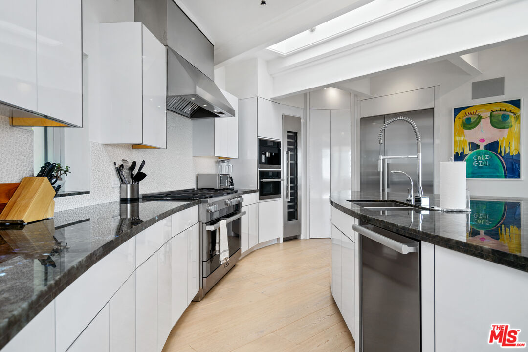 6375 Gayton Place Malibu, CA 90265 - Photo 19 of 49 a kitchen with stainless steel appliances granite countertop a sink stove and refrigerator