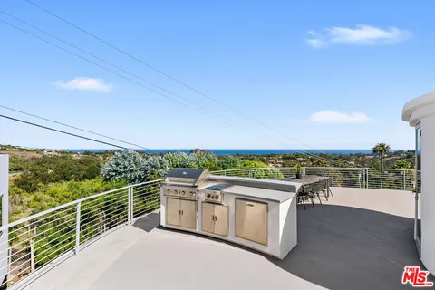 a view of a balcony with two chairs