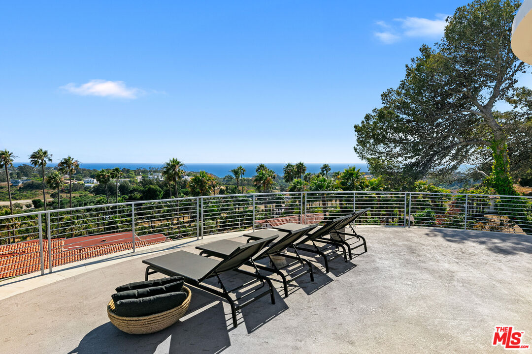 6375 Gayton Place Malibu, CA 90265 - Photo 25 of 49 a view of a terrace with a table and chairs