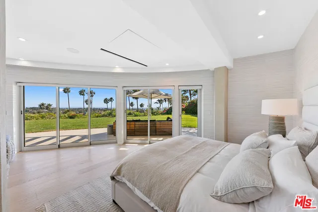a bedroom with furniture and a wooden floor