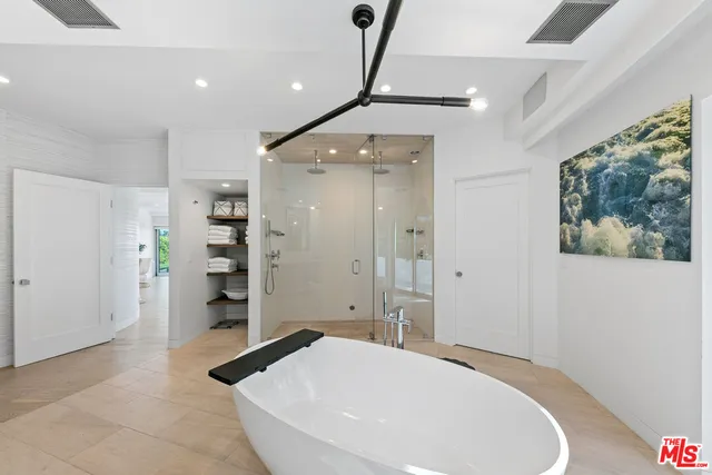 a bed room with two bed and a large window