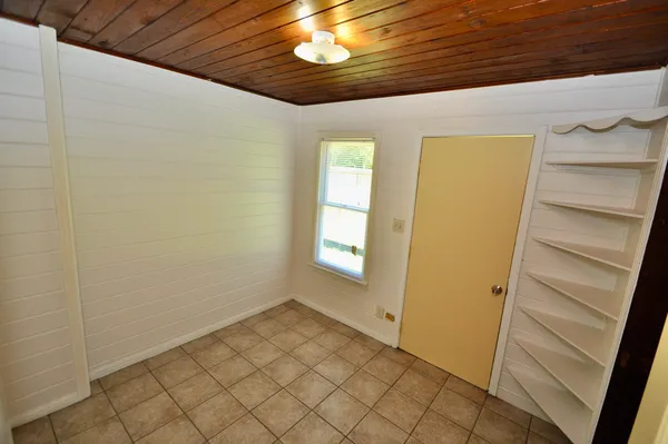 a view of room with window and chandelier