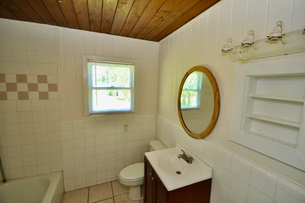 a bathroom with a bathtub and toilet