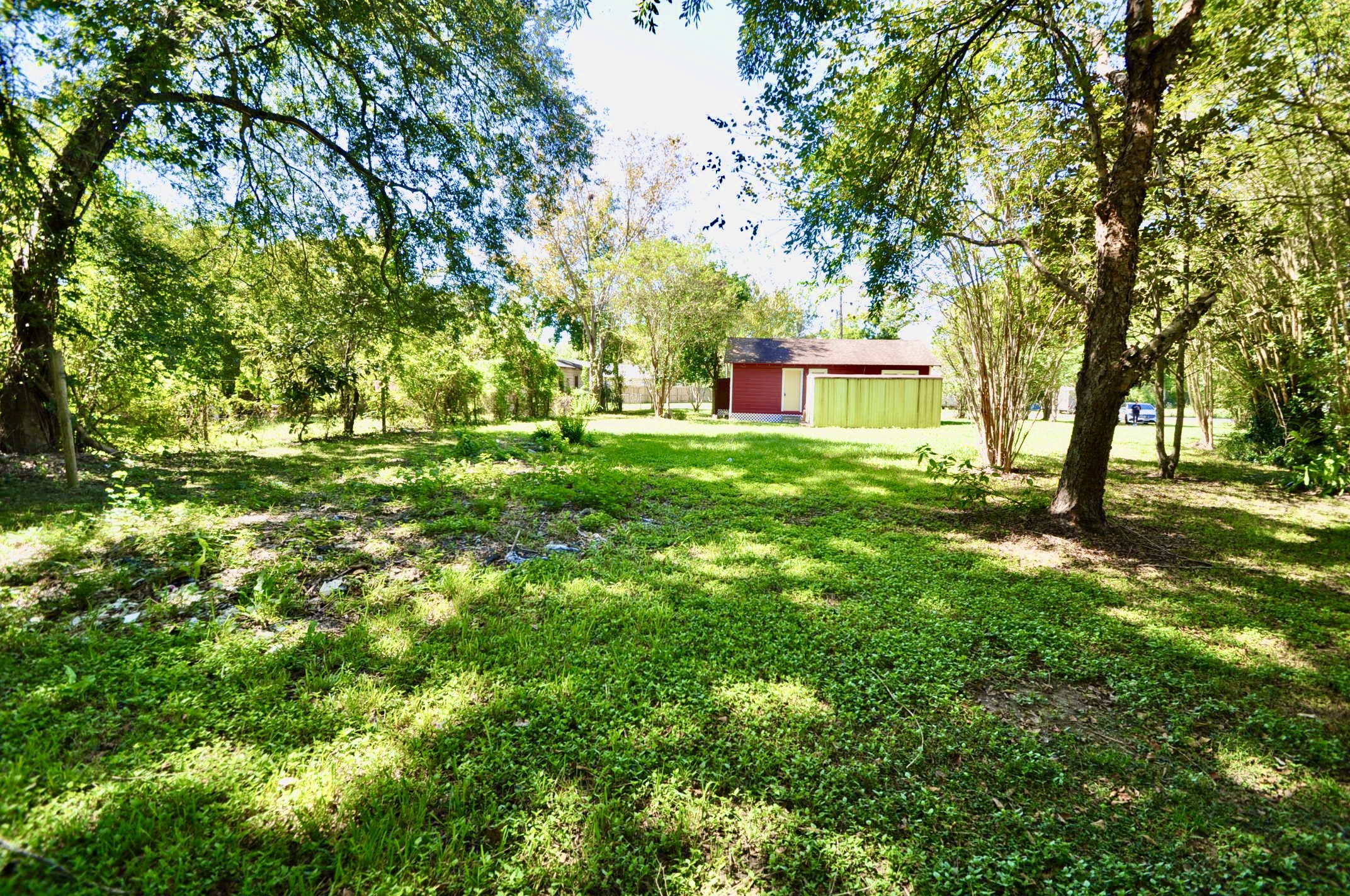 1807 Bell Street Dayton, TX 77535 - Photo 6 of 34 a house with lots of trees