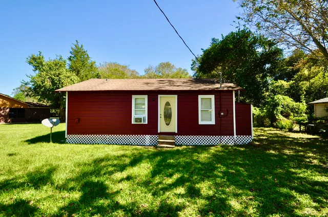 a front view of a house with garden