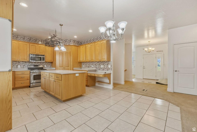 1001 Pine Valley Road Pine Valley, UT 84781 - Photo 16 of 49 Kitchen with suspended lighting, light carpet, light tile patterned flooring, stainless steel appliances, and a center island