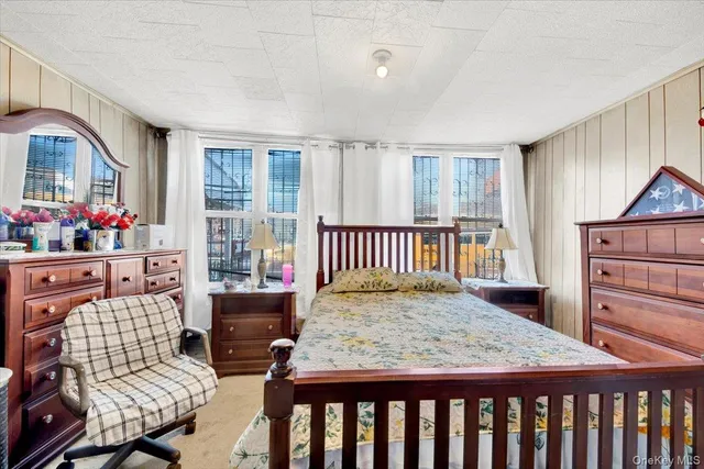 a bedroom with furniture and a window