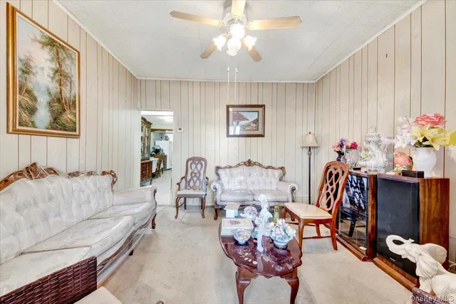 a living room with furniture flowerpot and a chandelier