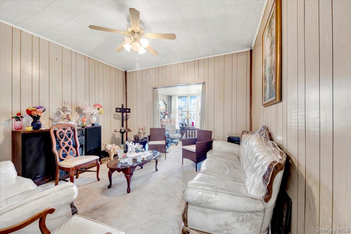 1238 Colgate Avenue Bronx, NY 10472 - Photo 13 of 20 a living room with furniture and a chandelier