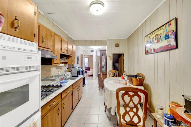 a large living room with stainless steel appliances furniture a fireplace and a flat screen tv