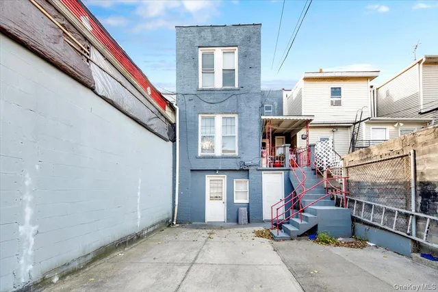 a view of a brick house with large windows and refrigerator
