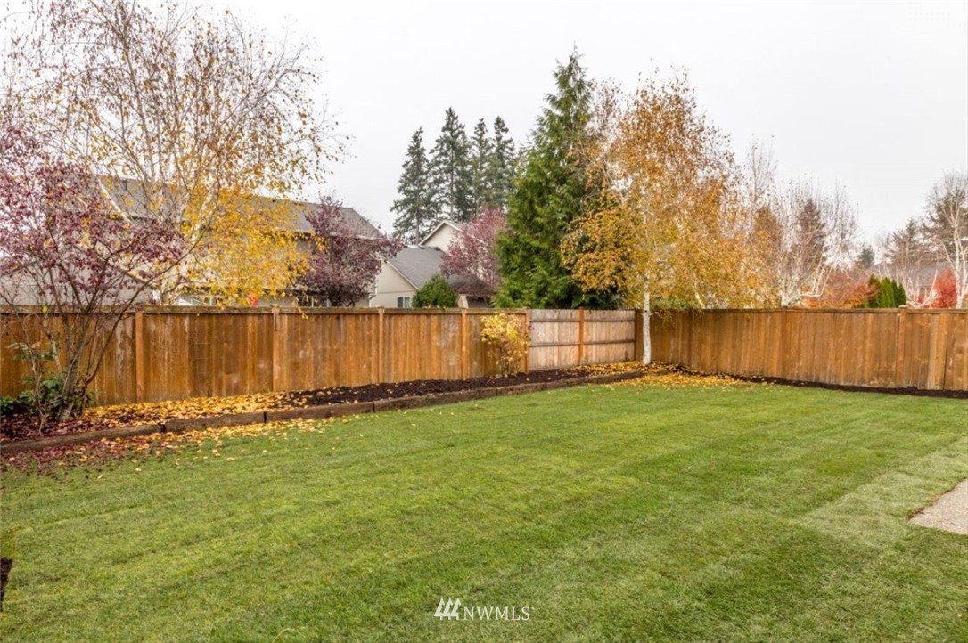 8341 49th Loop Southeast Olympia, WA 98513 - Photo 25 of 25 a view of a yard with wooden fence