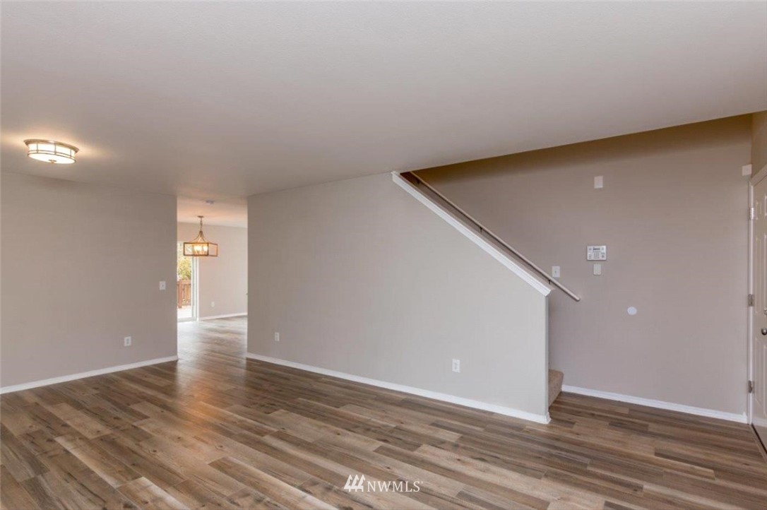 8341 49th Loop Southeast Olympia, WA 98513 - Photo 5 of 25 a view of an empty room with wooden floor