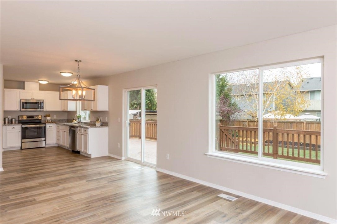 8341 49th Loop Southeast Olympia, WA 98513 - Photo 6 of 25 a open kitchen with stainless steel appliances granite countertop a stove and a sink