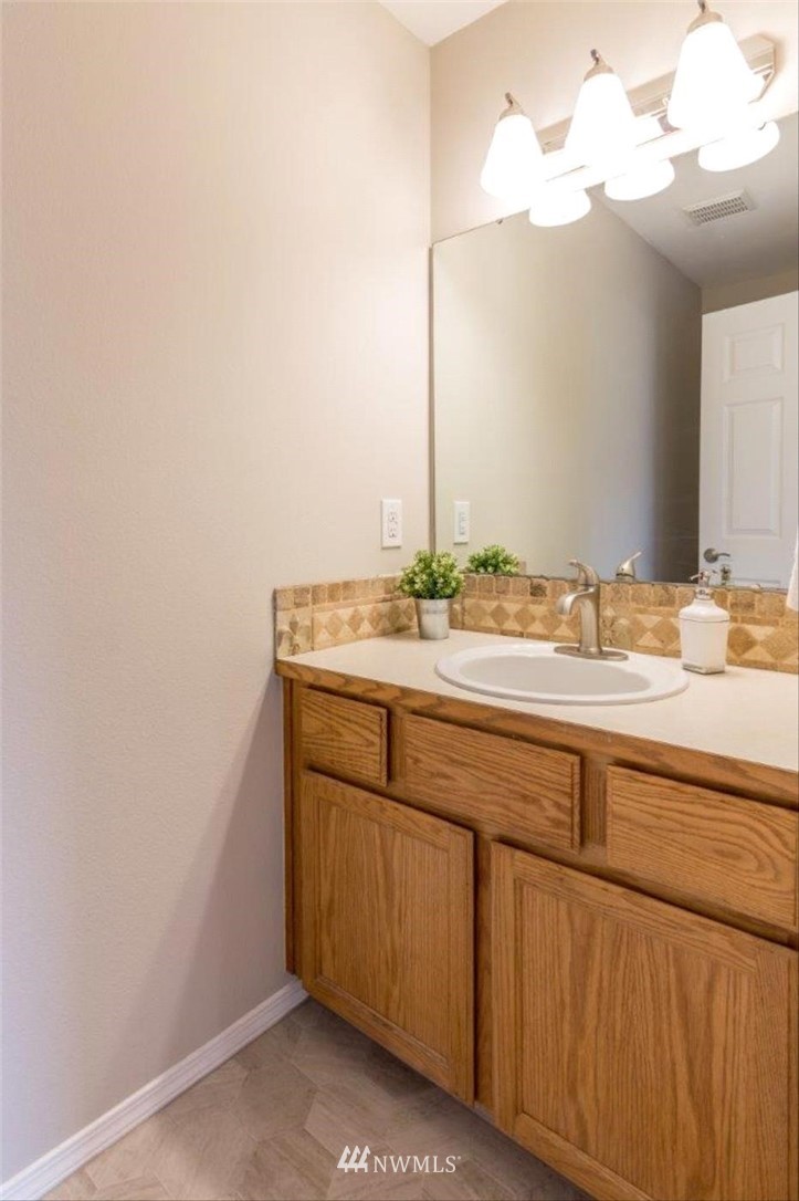 8341 49th Loop Southeast Olympia, WA 98513 - Photo 9 of 25 a bathroom with a sink and a mirror