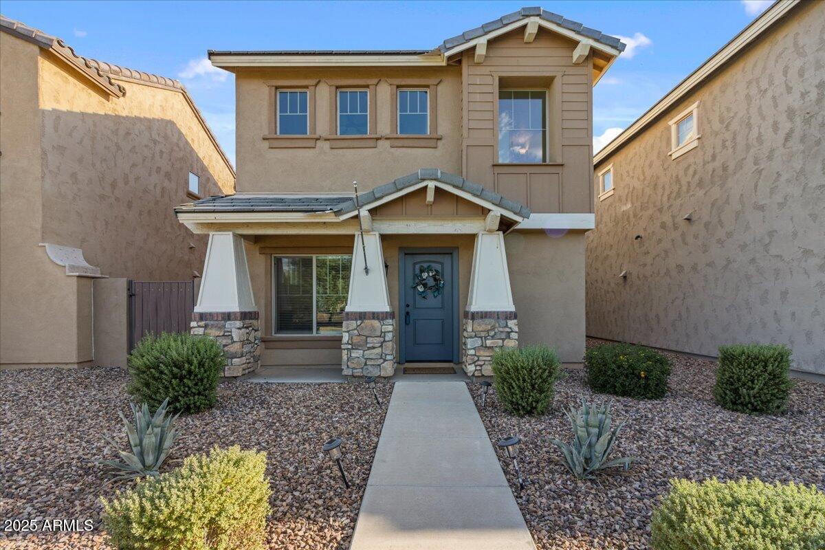 a front view of a house with garden