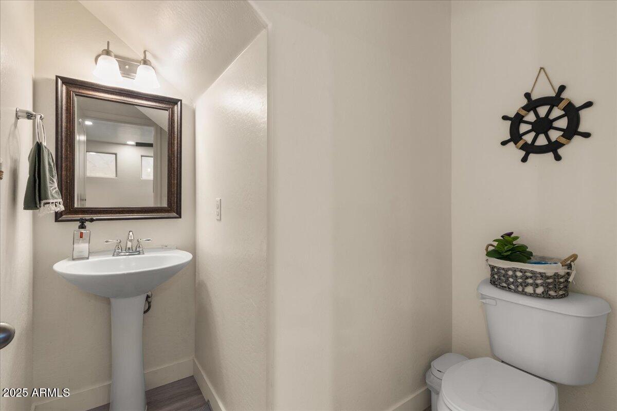 11452 West St John Road Surprise, AZ 85378 - Photo 10 of 29 a bathroom with a toilet sink and mirror