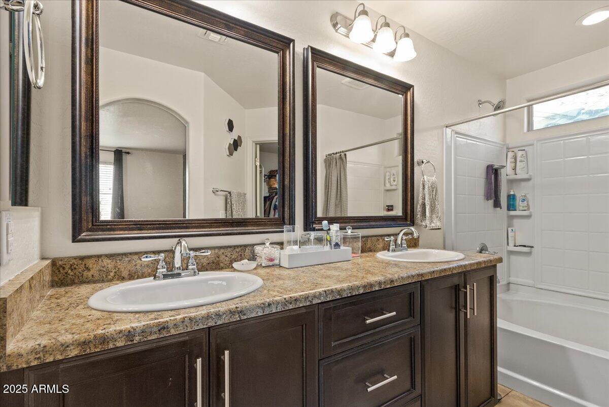 11452 West St John Road Surprise, AZ 85378 - Photo 13 of 29 a bathroom with a granite countertop sink and a mirror