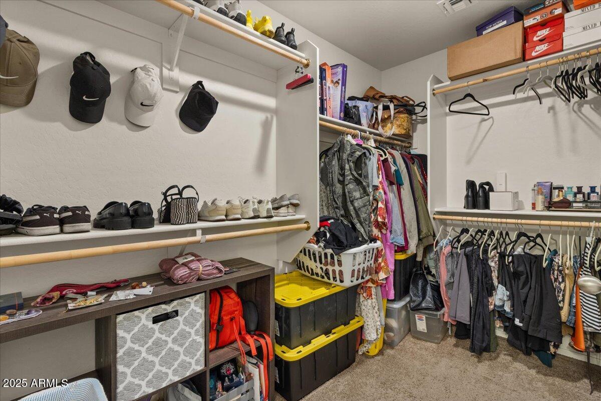 11452 West St John Road Surprise, AZ 85378 - Photo 14 of 29 a view of walk in closet with clothes and shoes