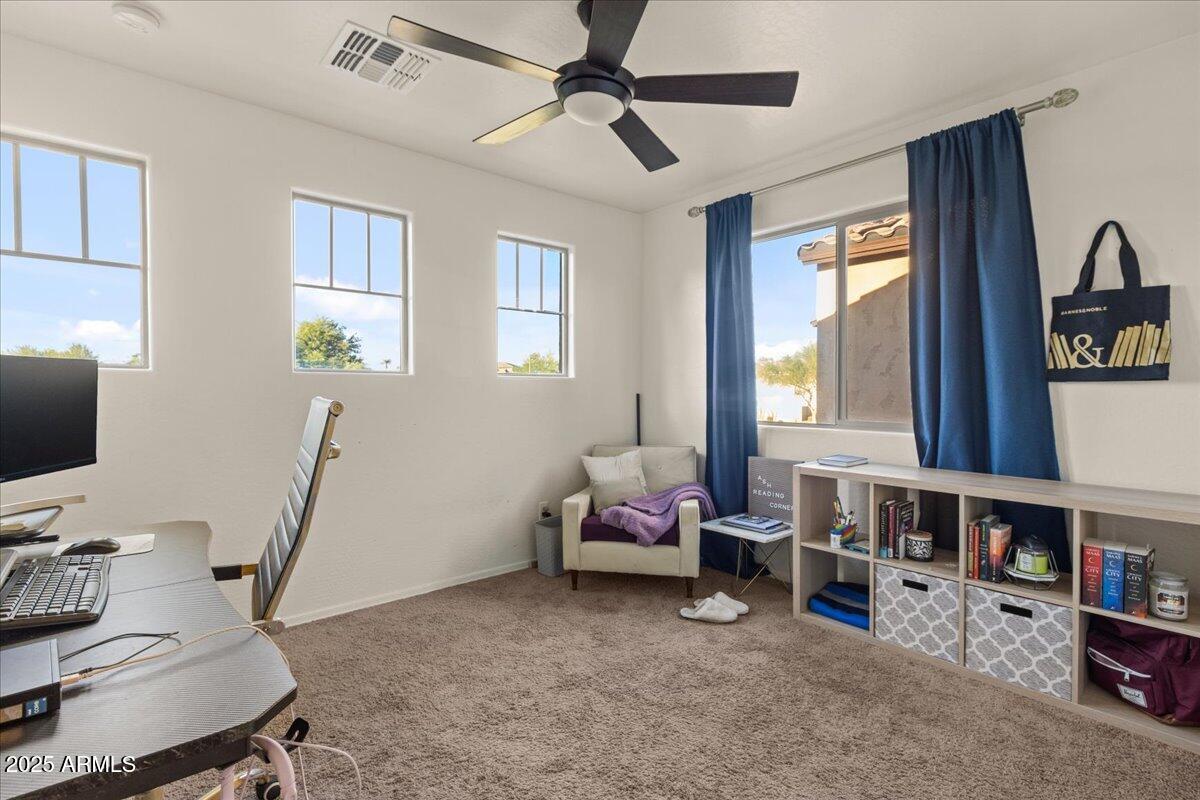11452 West St John Road Surprise, AZ 85378 - Photo 15 of 29 a living room with furniture and a flat screen tv