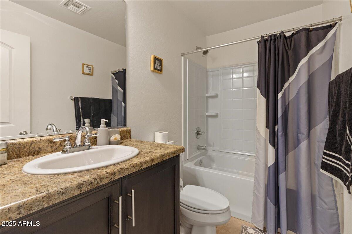 11452 West St John Road Surprise, AZ 85378 - Photo 17 of 29 a bathroom with a granite countertop sink toilet and shower