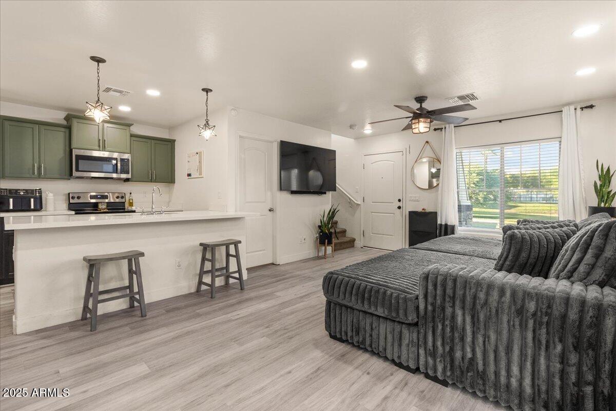 11452 West St John Road Surprise, AZ 85378 - Photo 5 of 29 a large bedroom with a bed a couches and flat screen tv