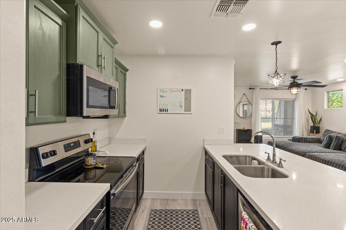 11452 West St John Road Surprise, AZ 85378 - Photo 9 of 29 a kitchen that has a sink and a stove