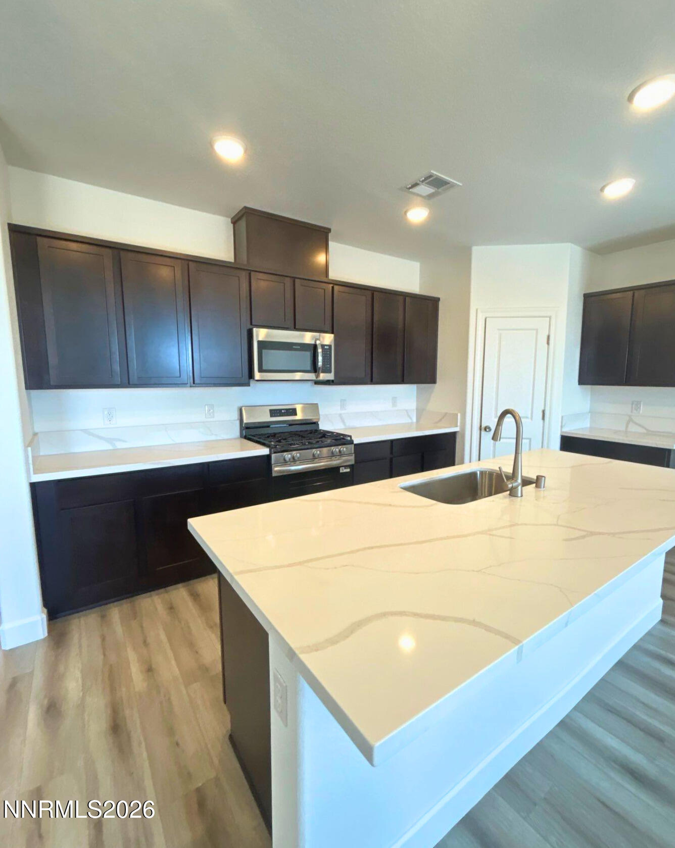3453 Payton Way Fernley, NV 89408 - Photo 4 of 15 a kitchen with stainless steel appliances granite countertop a sink a stove a microwave a sink and a refrigerator