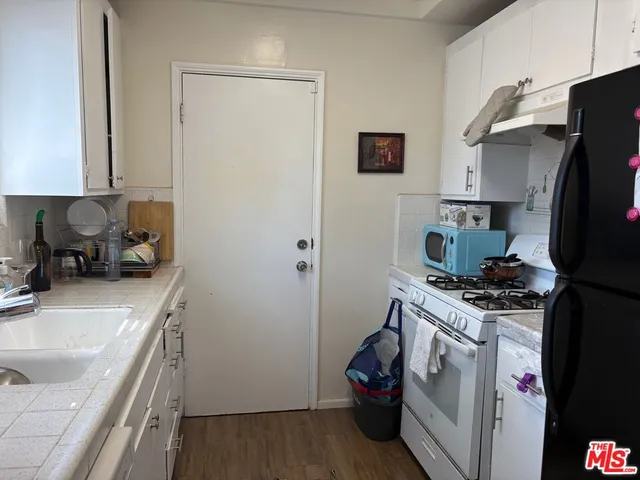 a kitchen with a sink stove and refrigerator