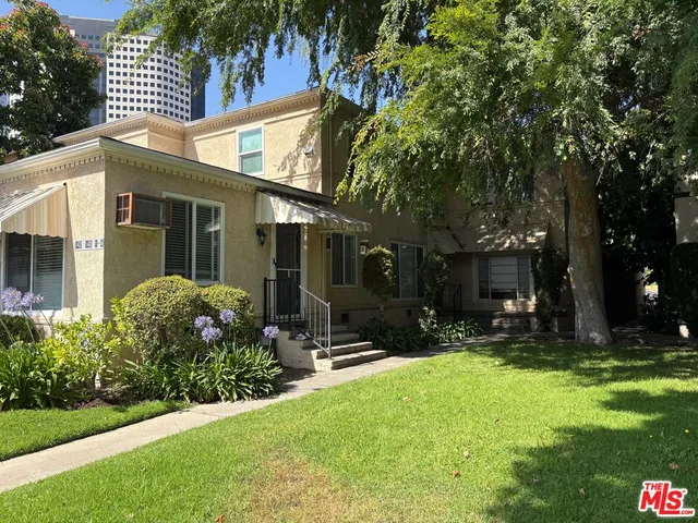 a view of a chair and table in backyard of the house
