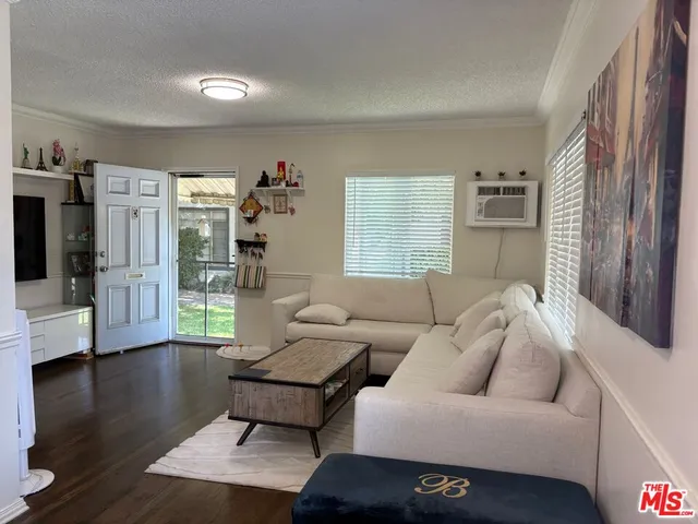 a living room with furniture window and wooden floor