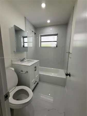 a large kitchen with a stove a sink dishwasher and a refrigerator