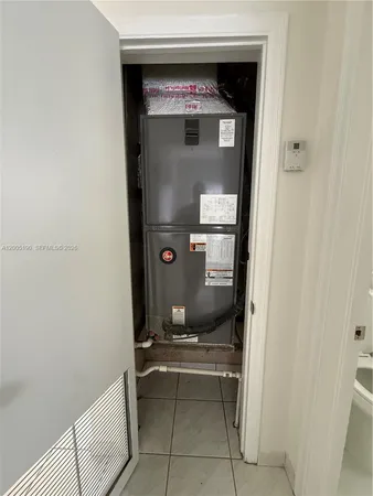 a kitchen with white cabinets and refrigerator