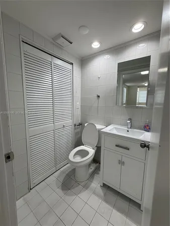 a bathroom with a sink vanity and mirror