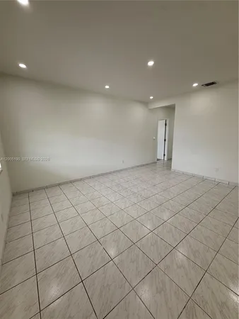a view of an empty room and a window