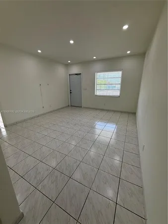 a view of an empty room and a window