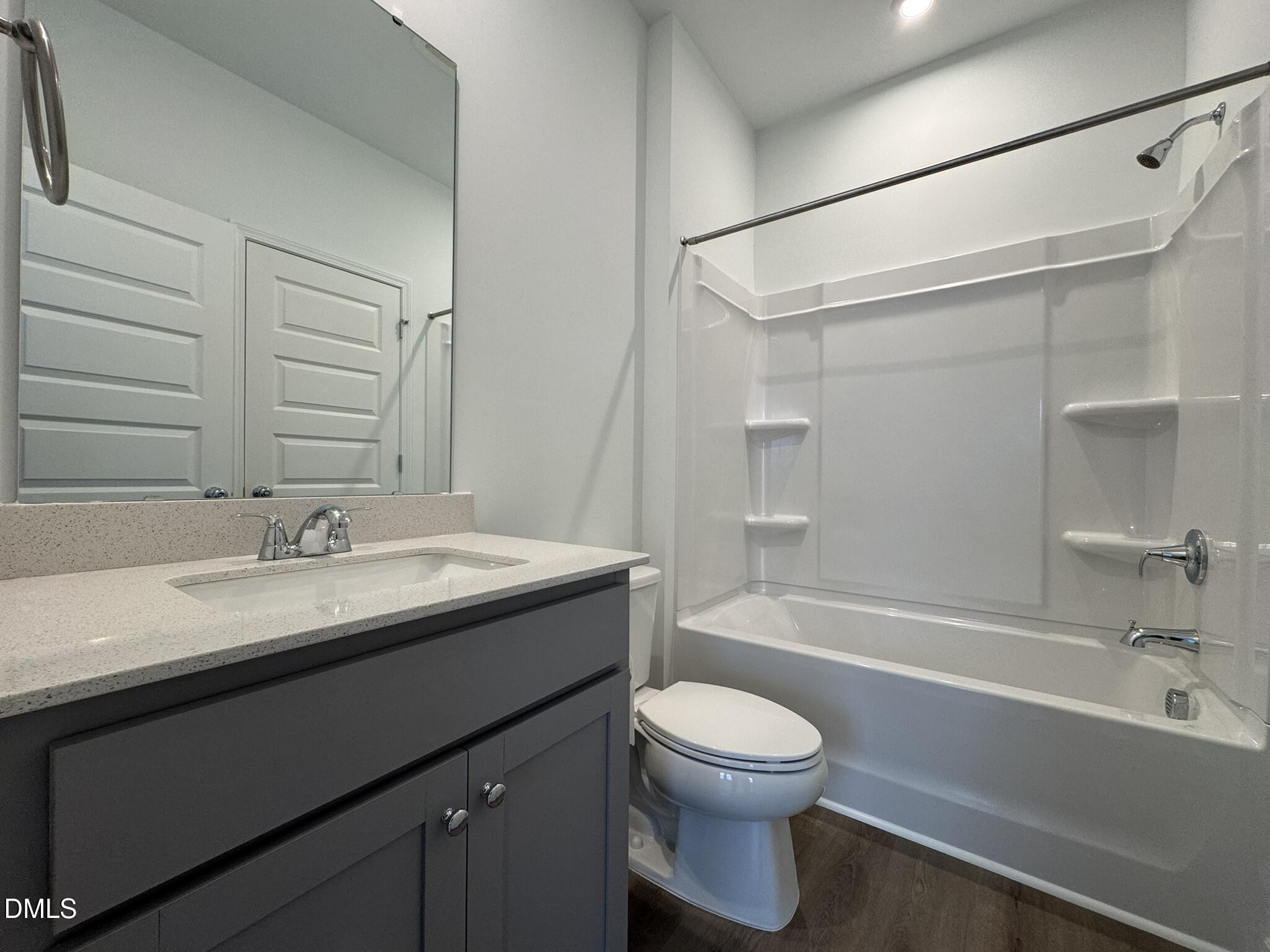3312 Bomore Road Raleigh, NC 27610 - Photo 11 of 20 a bathroom with a granite countertop sink toilet and shower