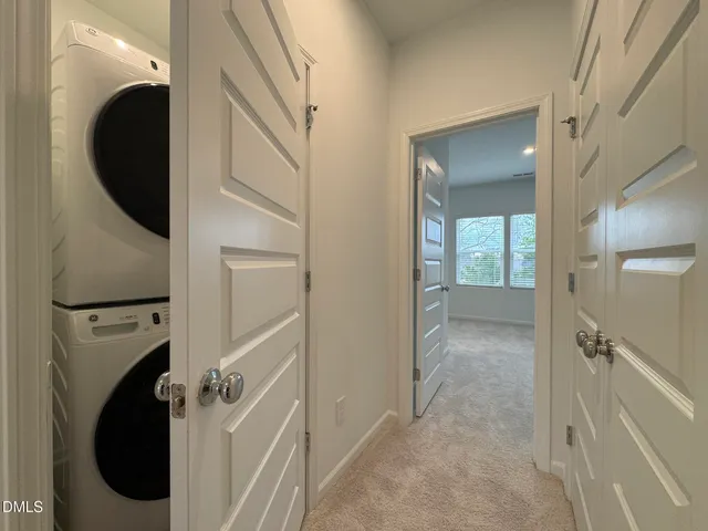 a view of a hallway with washer and dryer