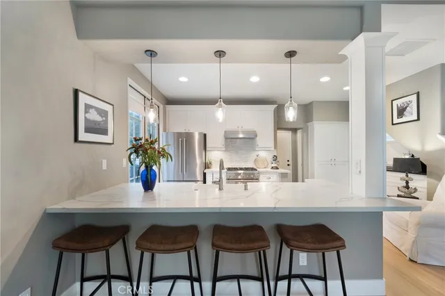 a large kitchen with a table and chairs