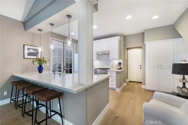 a kitchen with stainless steel appliances a stove a refrigerator and a refrigerator